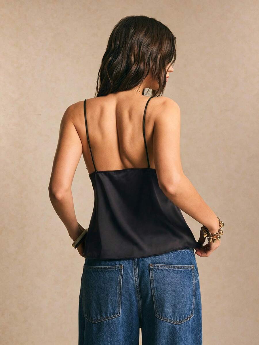 Women's polka dot lace patchwork pleated camisole top featuring an asymmetrical hem and spaghetti straps.