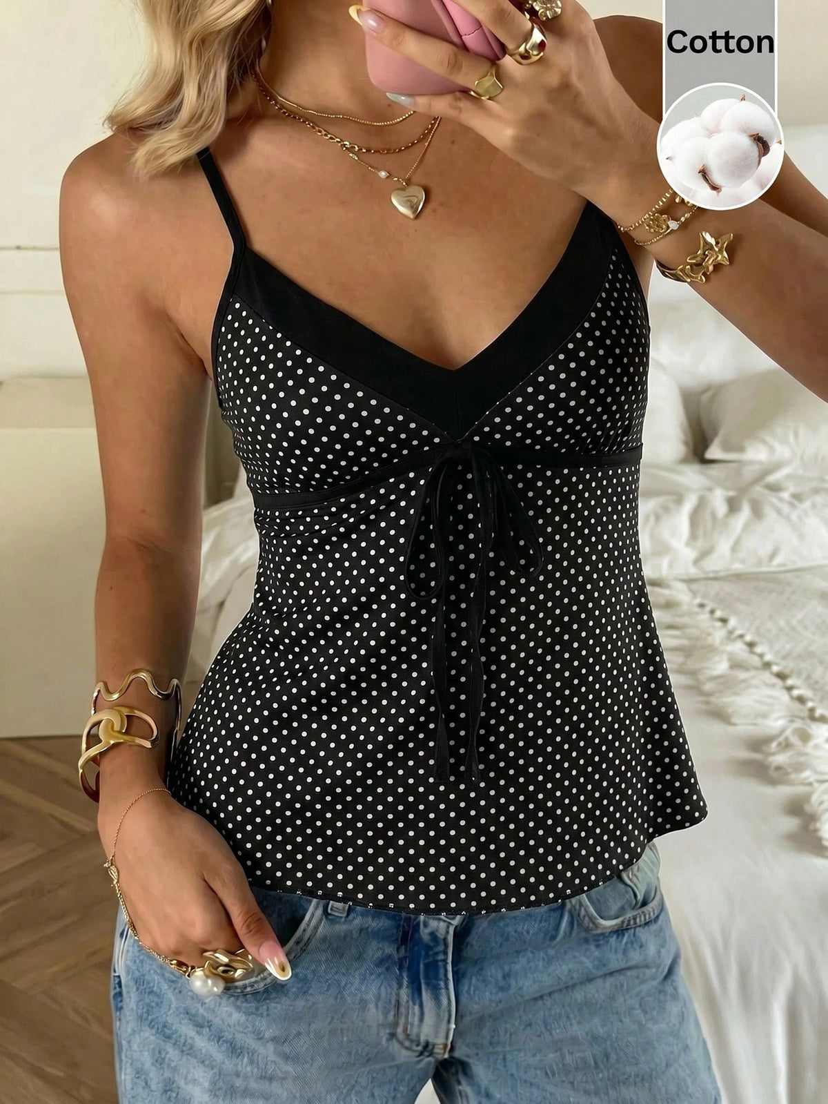 Black and white polka dot tie strap camisole top for women with thin spaghetti straps and slim fit.