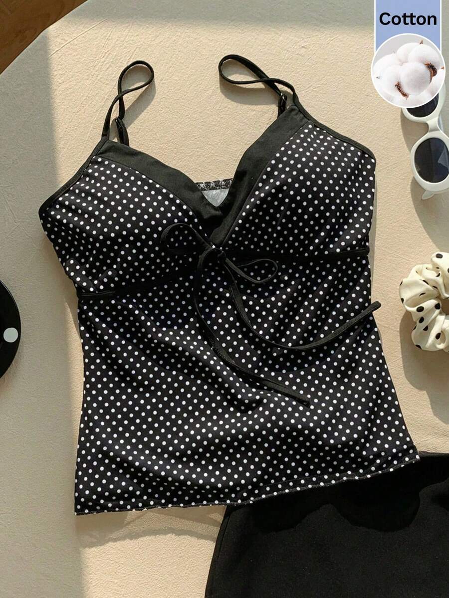 Black and white polka dot tie strap camisole top for women with thin spaghetti straps and slim fit.