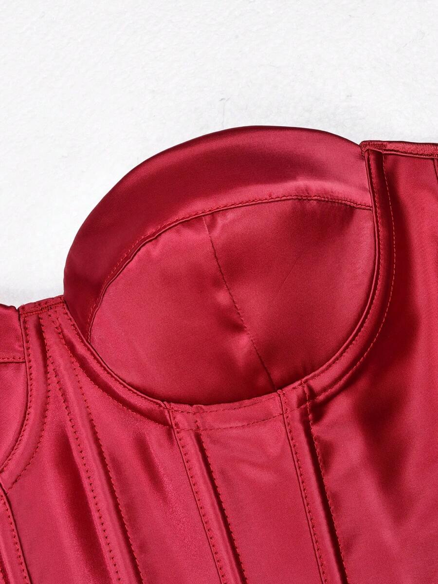 White women’s corset top with metal eyelet details, boning structure, spaghetti straps, backless tie-back design, and a slim cropped fit.