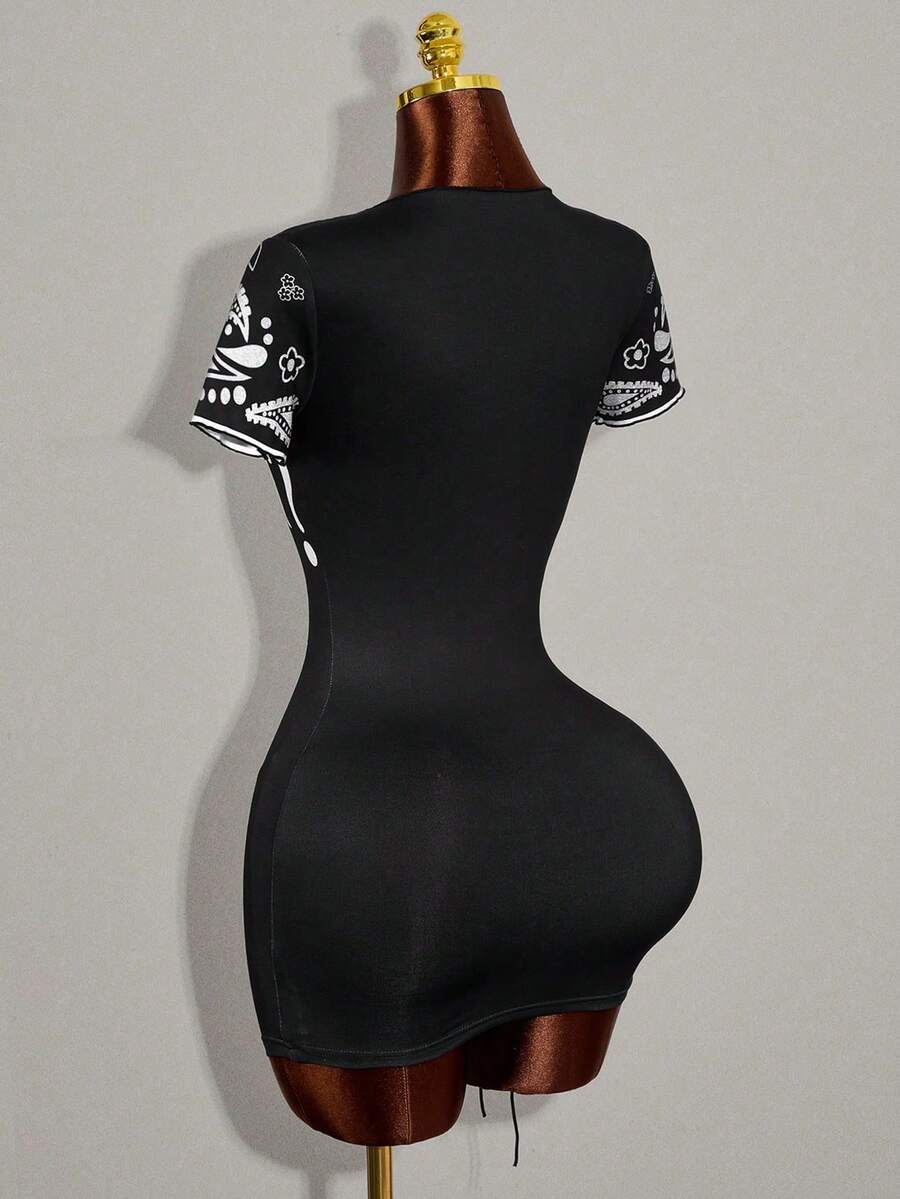 Women's black bodycon mini dress featuring grommet eyelet lace-up front detail, drop shoulder short sleeves, and slim fit stretch knit fabric.