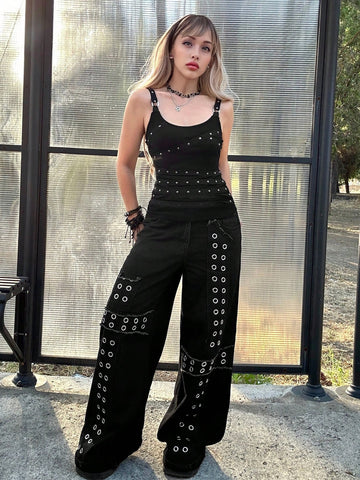 Women's black wide-strap cami top featuring rhinestone embellishments, cut-out accents, and grommet eyelets.