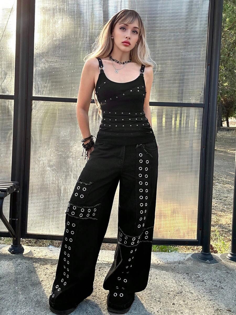 Women's black wide-strap cami top featuring rhinestone embellishments, cut-out accents, and grommet eyelets.