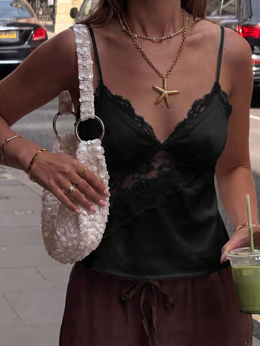 Black woven contrast lace camisole top featuring delicate spaghetti straps and a regular fit.