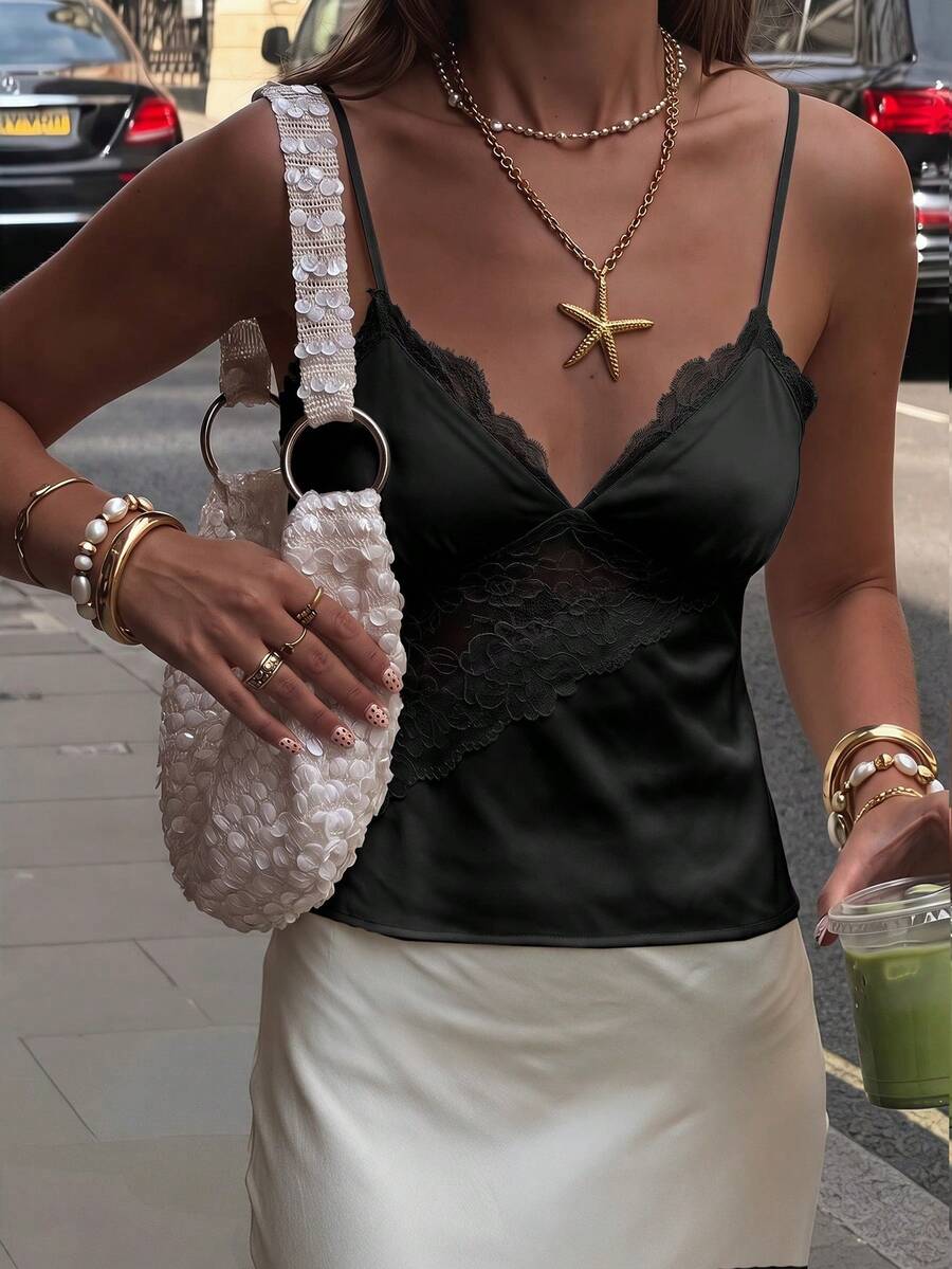Black woven contrast lace camisole top featuring delicate spaghetti straps and a regular fit.