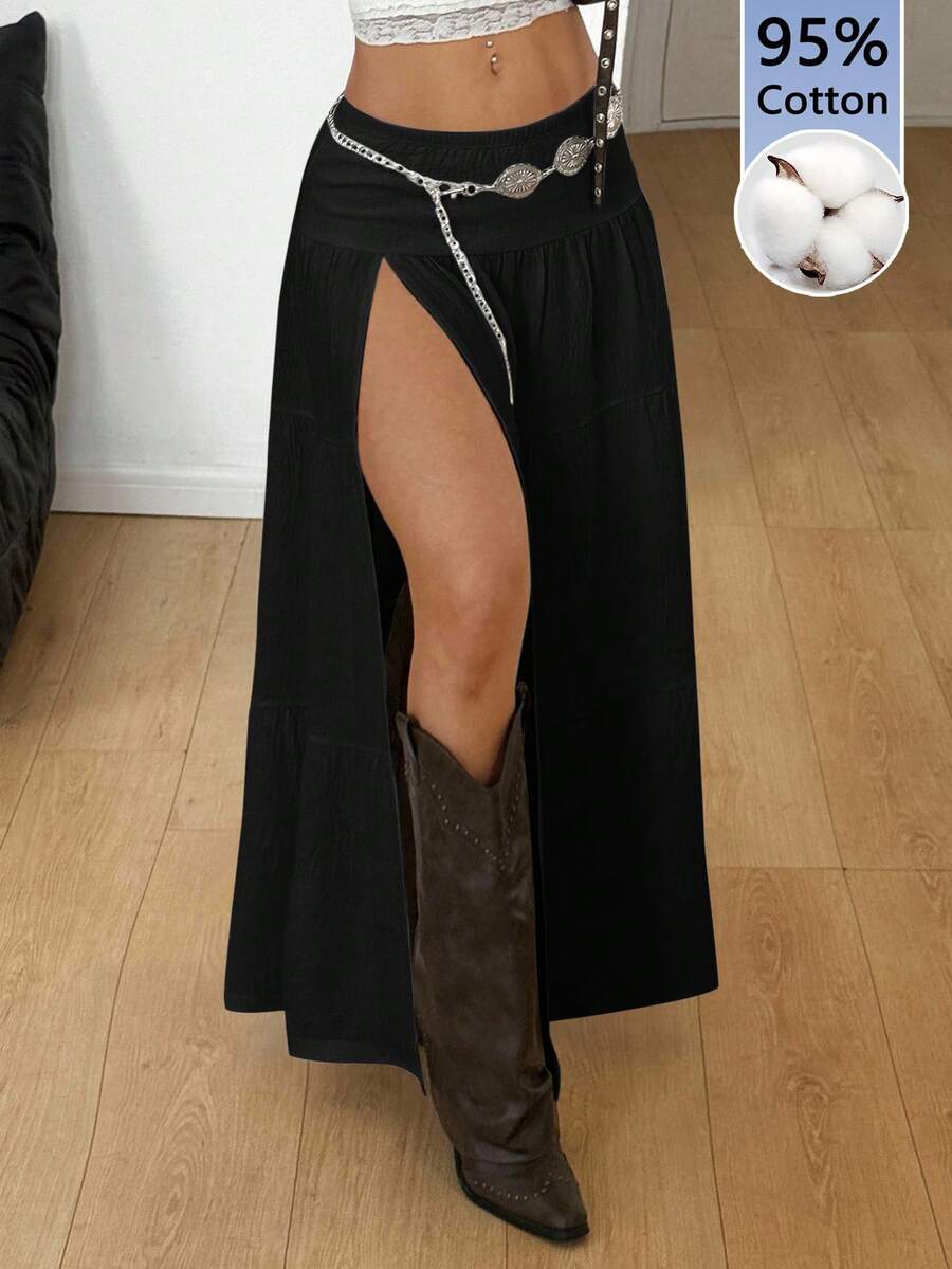 Women's black low waist split thigh long skirt featuring semi-sheer textured fabric and a flared skinny fit.