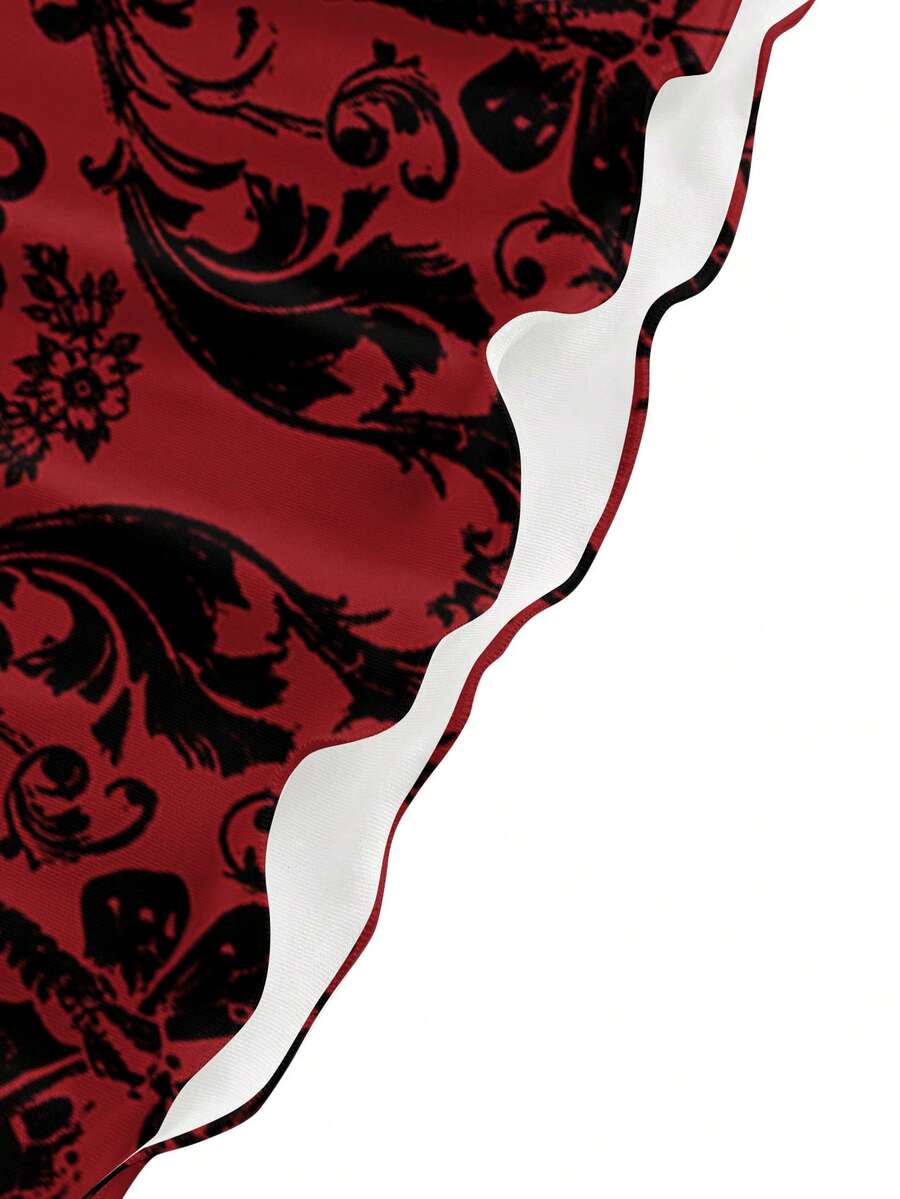 Women wearing a black gothic skull print backless cami mini dress with spaghetti straps and lettuce trim hem.