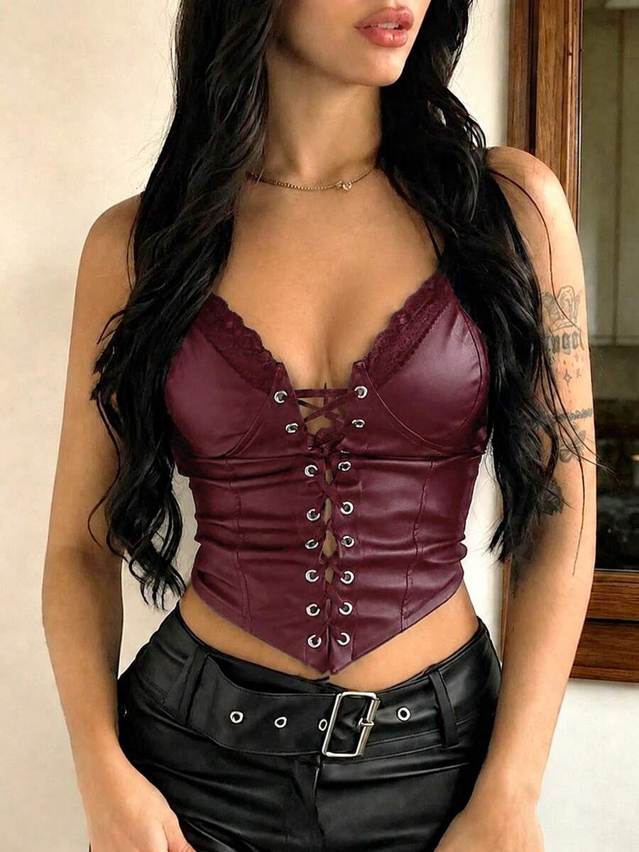Women's black PU leather fishbone corset crop top featuring a lace-up front with metal eyelets and an asymmetrical hem.