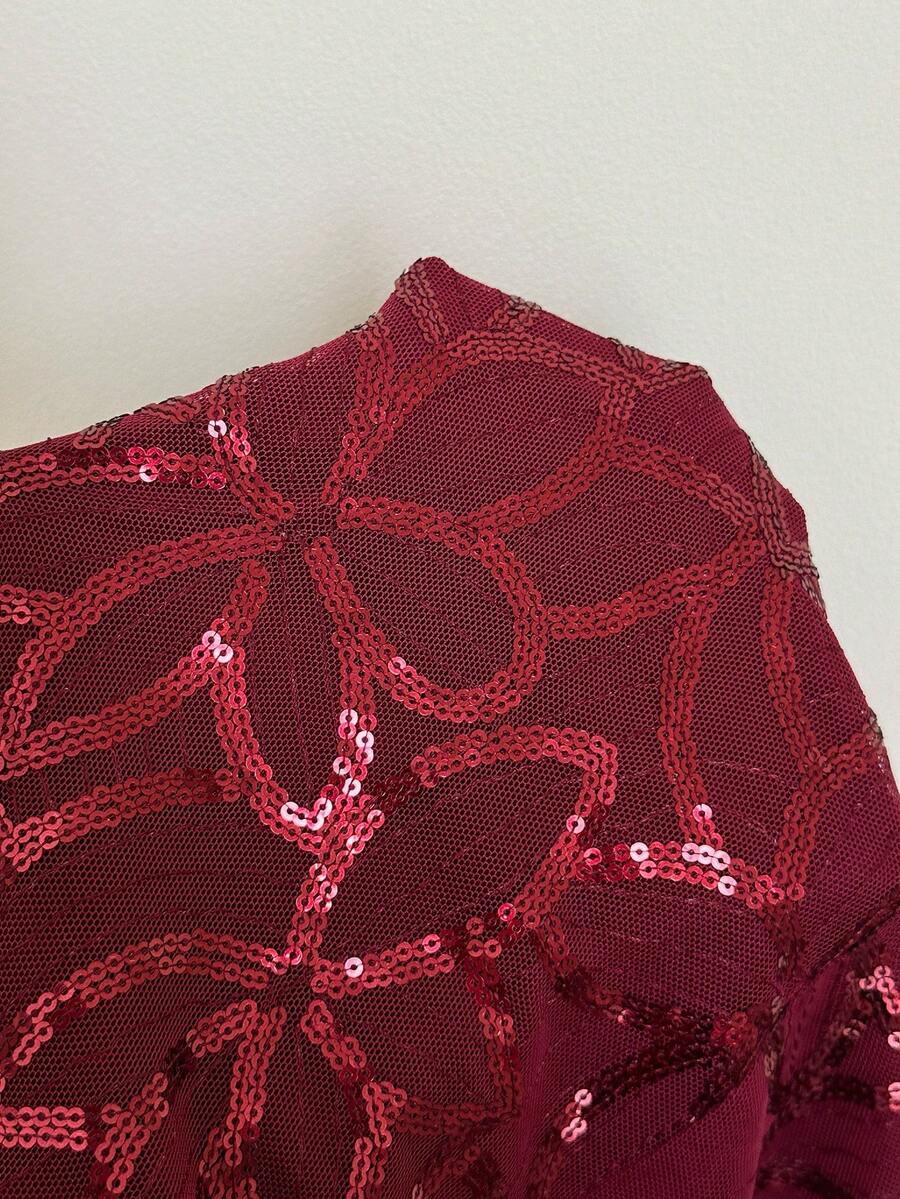 Burgundy shiny sequin bodycon mini skirt for women with low waist design, floral plant embroidery, and zipper detail.
