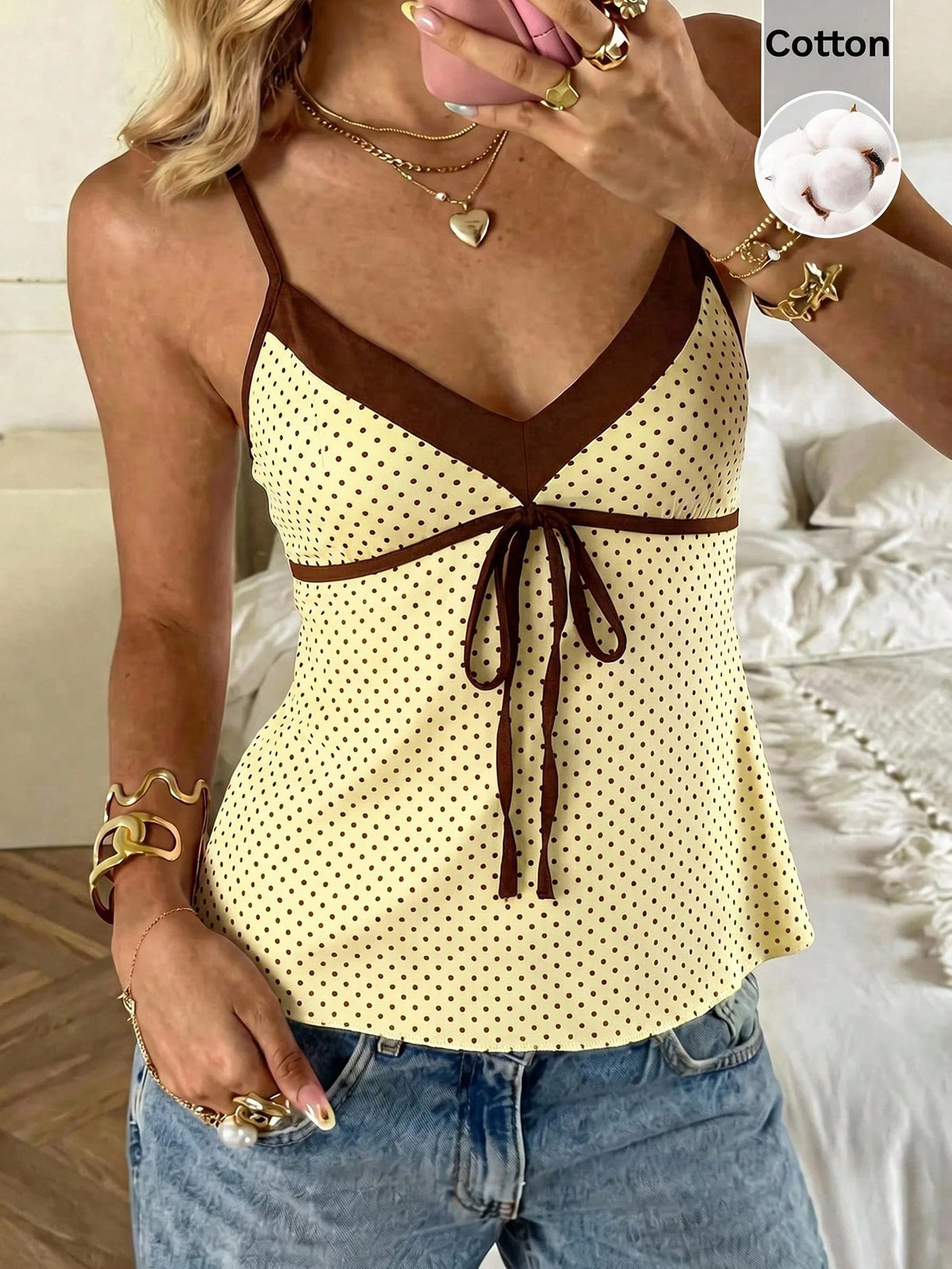 Black and white polka dot tie strap camisole top for women with thin spaghetti straps and slim fit.