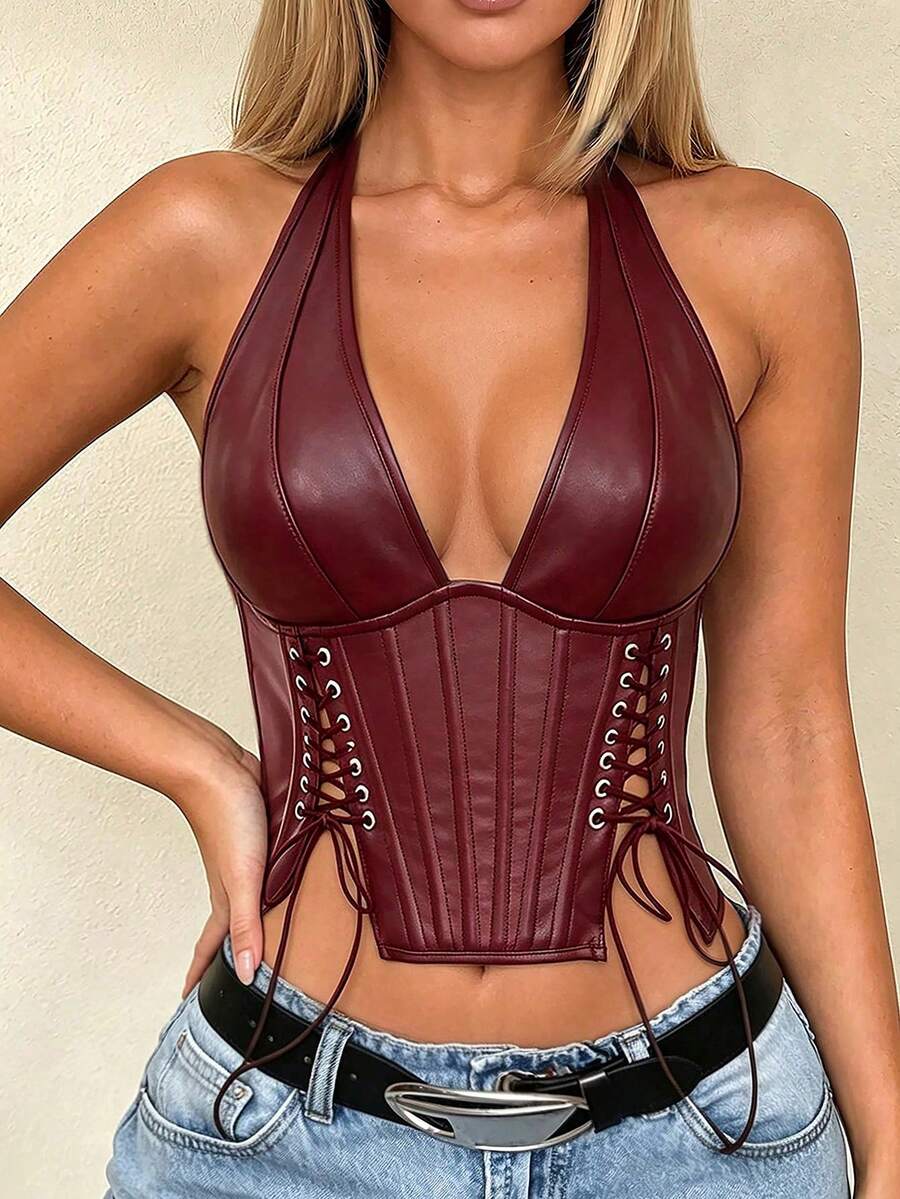 Black PU leather halter crop top for women with a backless design, split detail, tie-back closure, and grommet eyelets.
