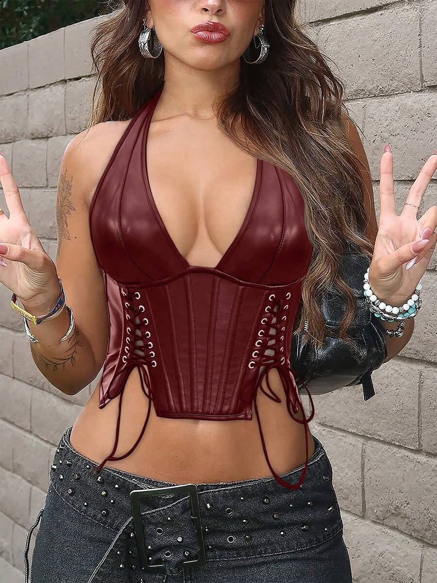 Black PU leather halter crop top for women with a backless design, split detail, tie-back closure, and grommet eyelets.