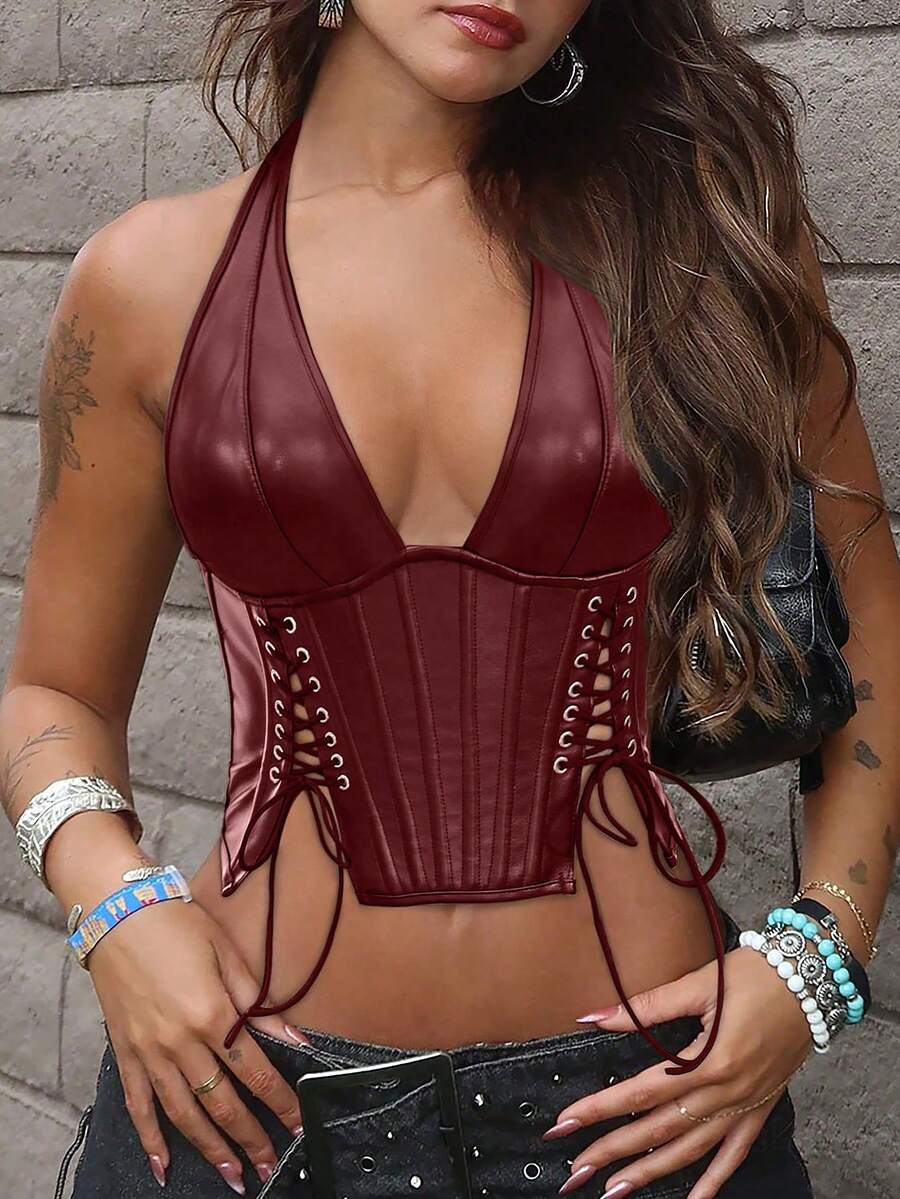 Black PU leather halter crop top for women with a backless design, split detail, tie-back closure, and grommet eyelets.