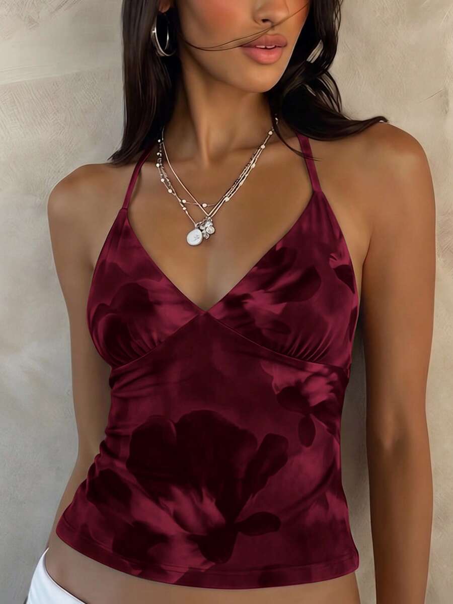 Women's black faux leather backless cami top with spaghetti straps and lace-up shirred sides.