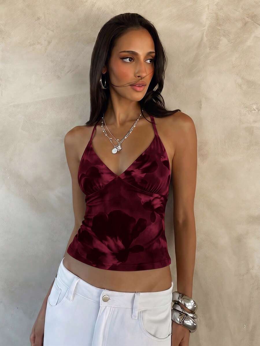 Women's black faux leather backless cami top with spaghetti straps and lace-up shirred sides.