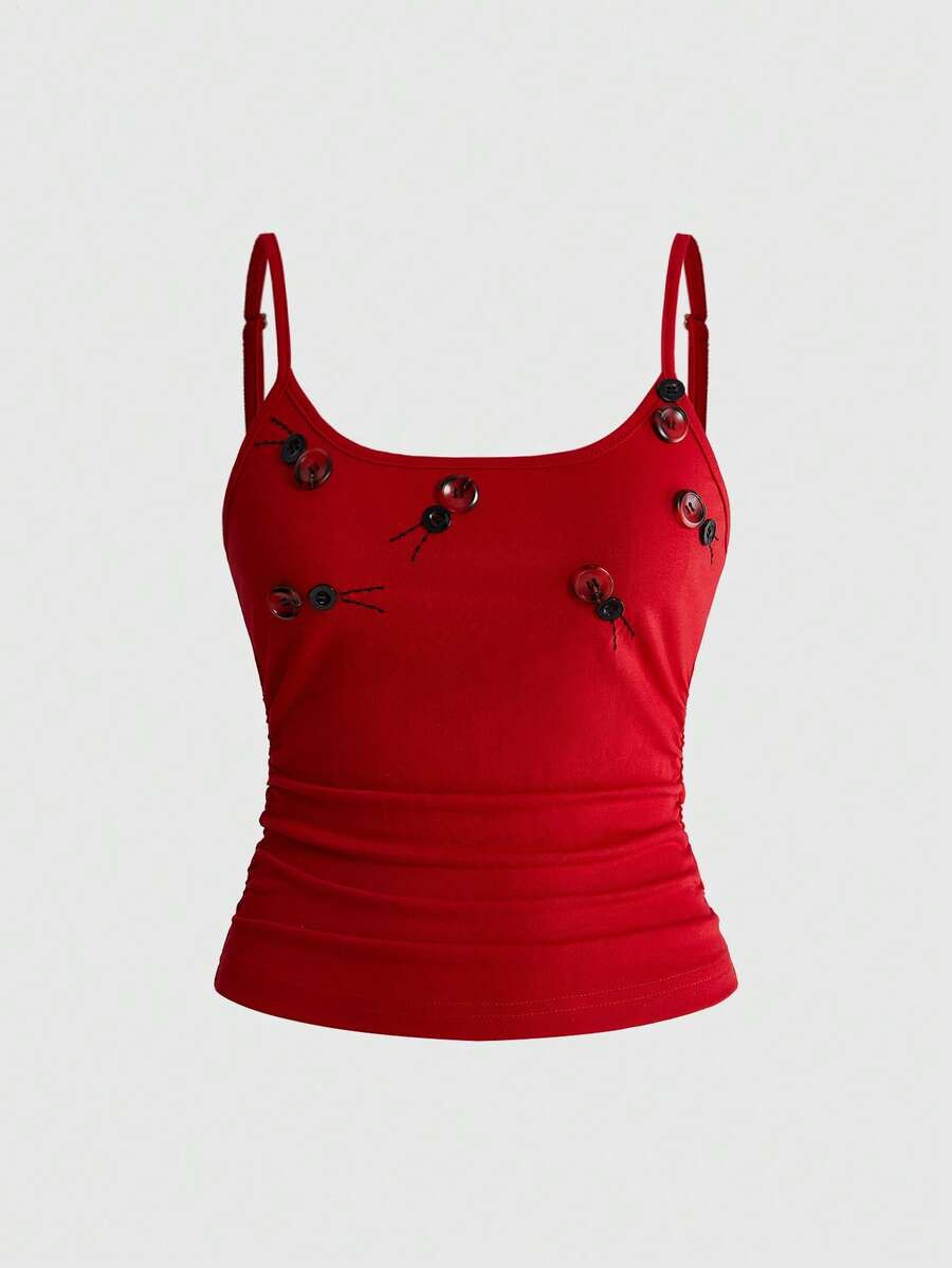 Woman wearing a black backless halter tank top with criss-cross details and textured knit fabric