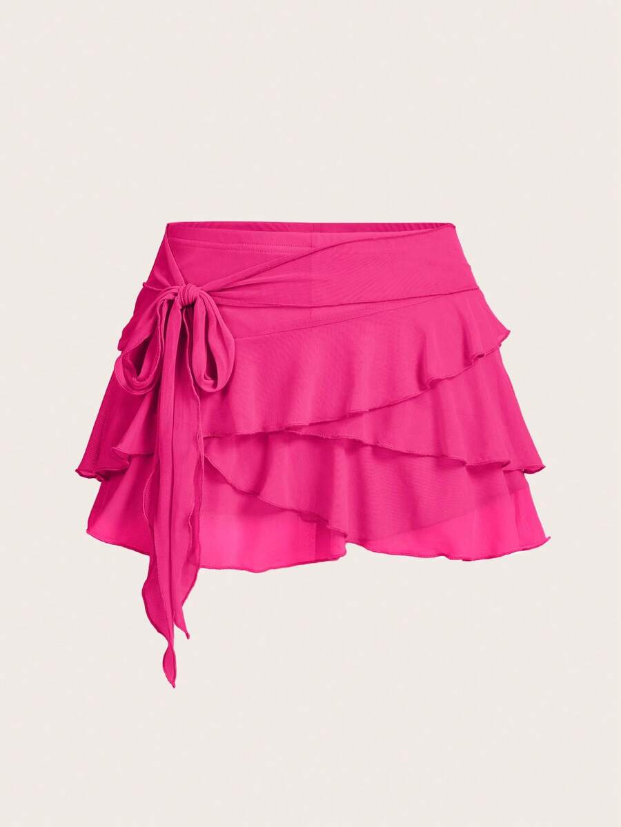 White tiered ruffle trim mini skirt for women with low waist, knot detail, mesh fabric, and casual Y2K boho design.