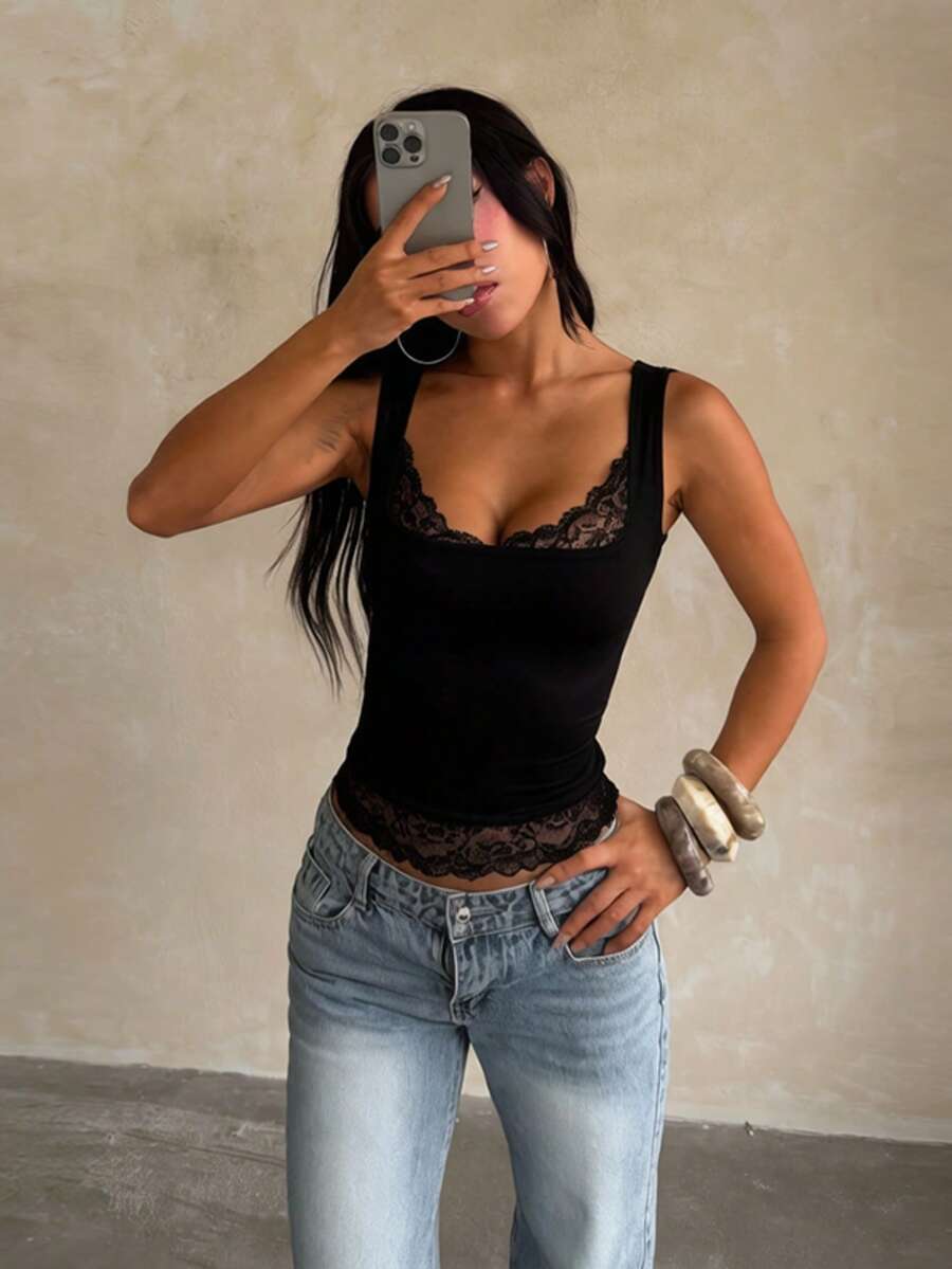 Women's white sleeveless crop top with contrast lace trim, shoulder straps, and a floral graphic print.