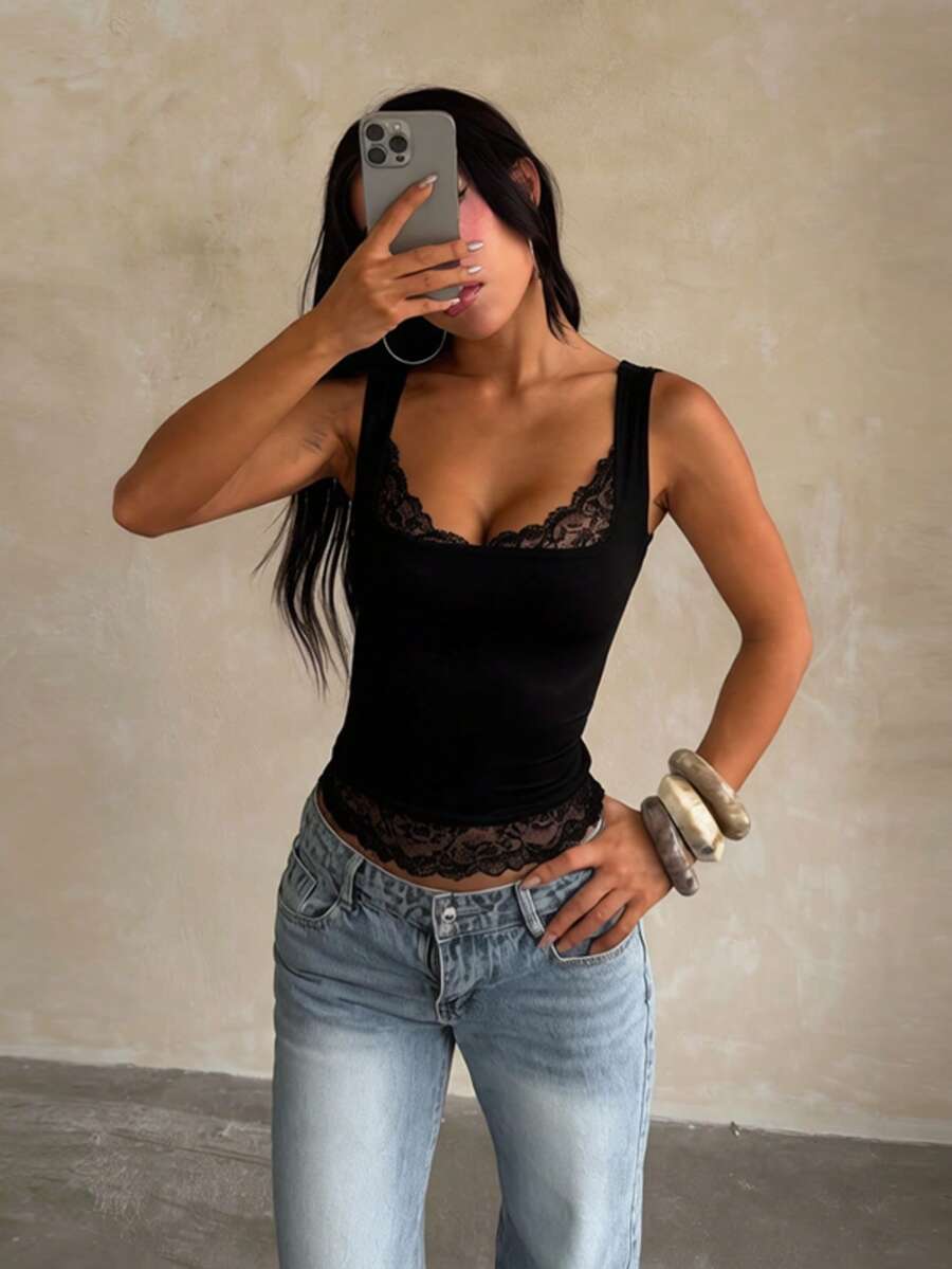 Women's white sleeveless crop top with contrast lace trim, shoulder straps, and a floral graphic print.