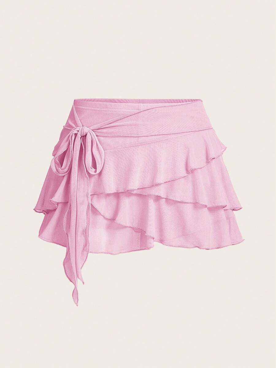 White tiered ruffle trim mini skirt for women with low waist, knot detail, mesh fabric, and casual Y2K boho design.