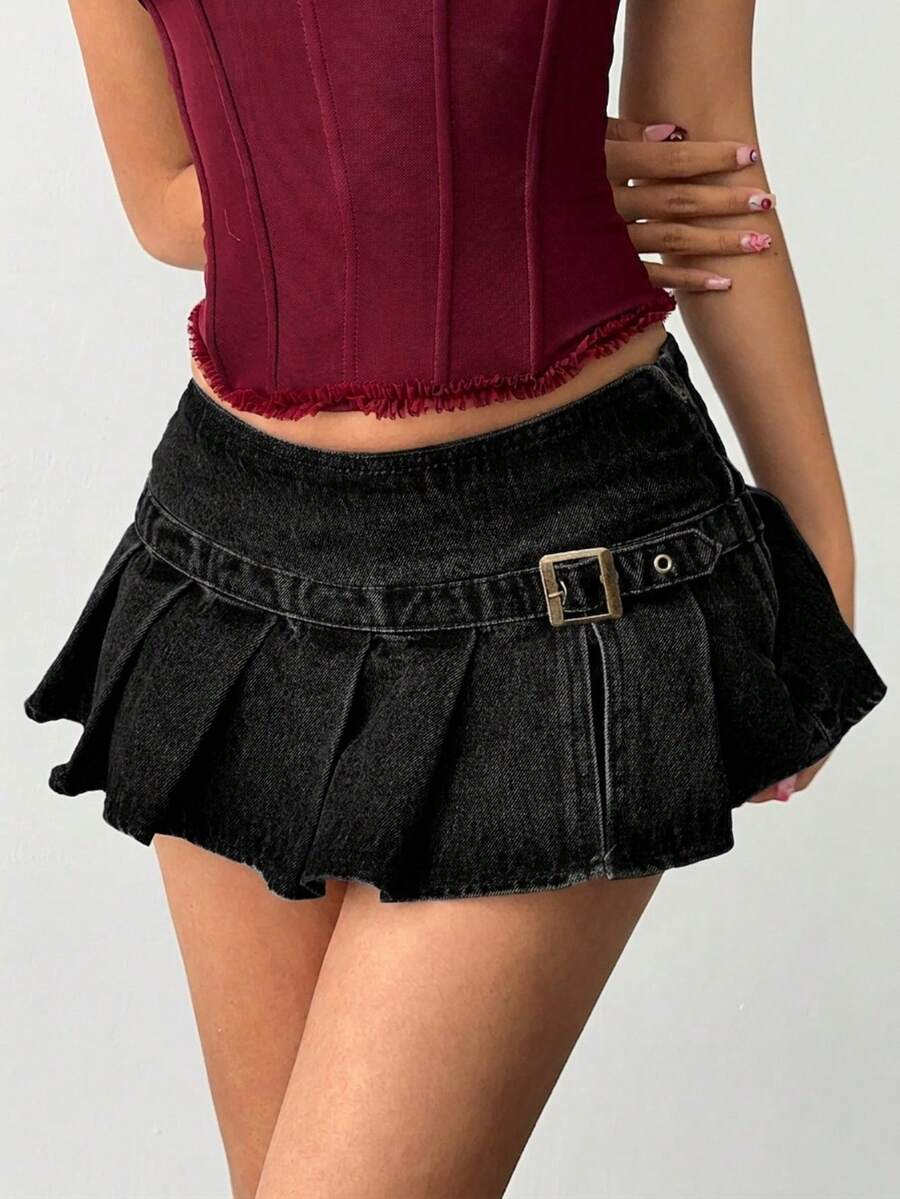 Women's blue denim pleated mini skirt skort featuring a low waist fit with zipper and grommet eyelet details.