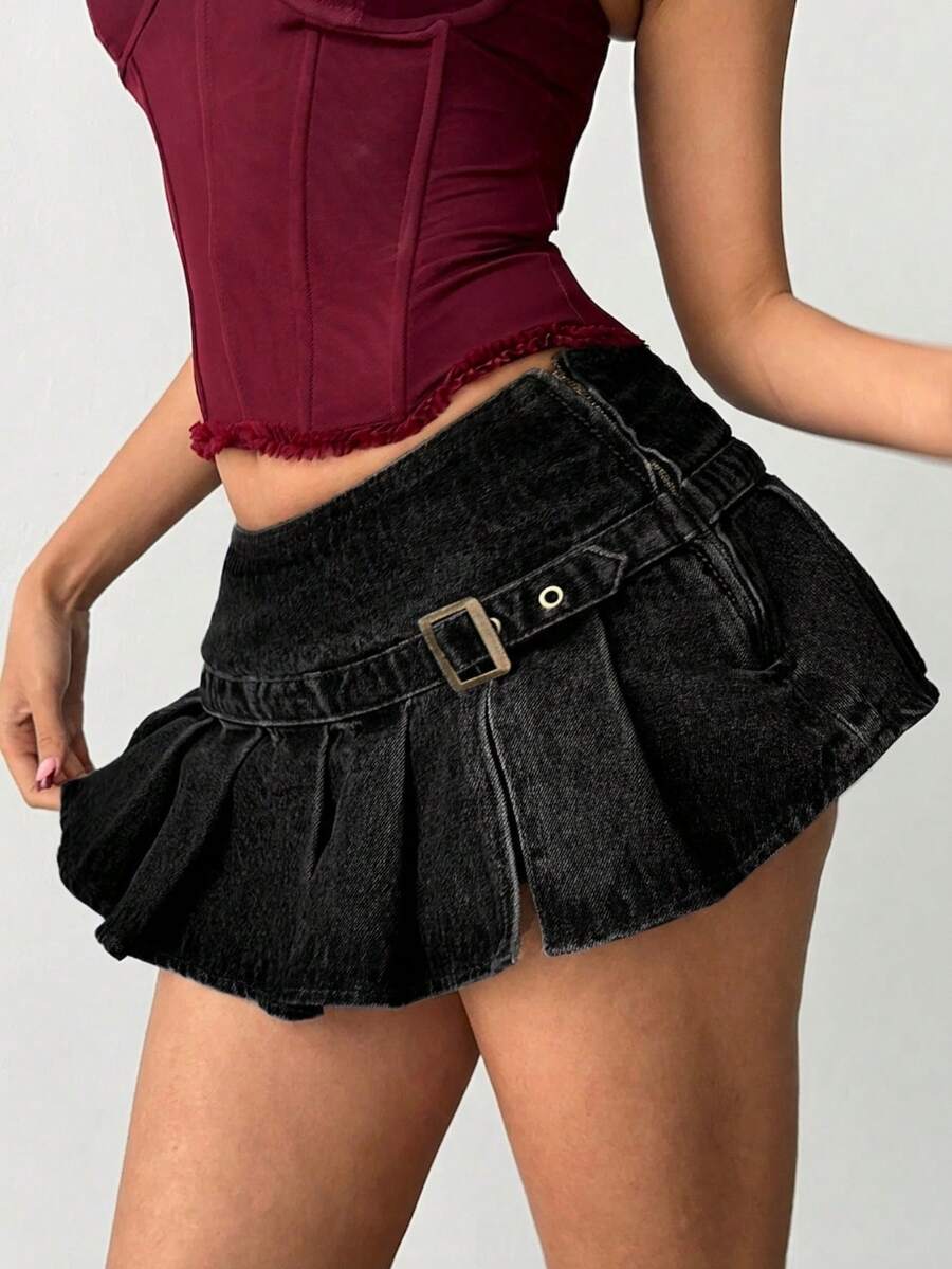 Women's blue denim pleated mini skirt skort featuring a low waist fit with zipper and grommet eyelet details.