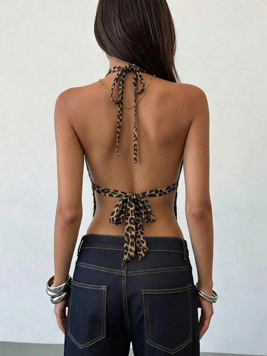 Women's black faux leather backless cami top with spaghetti straps and lace-up shirred sides.