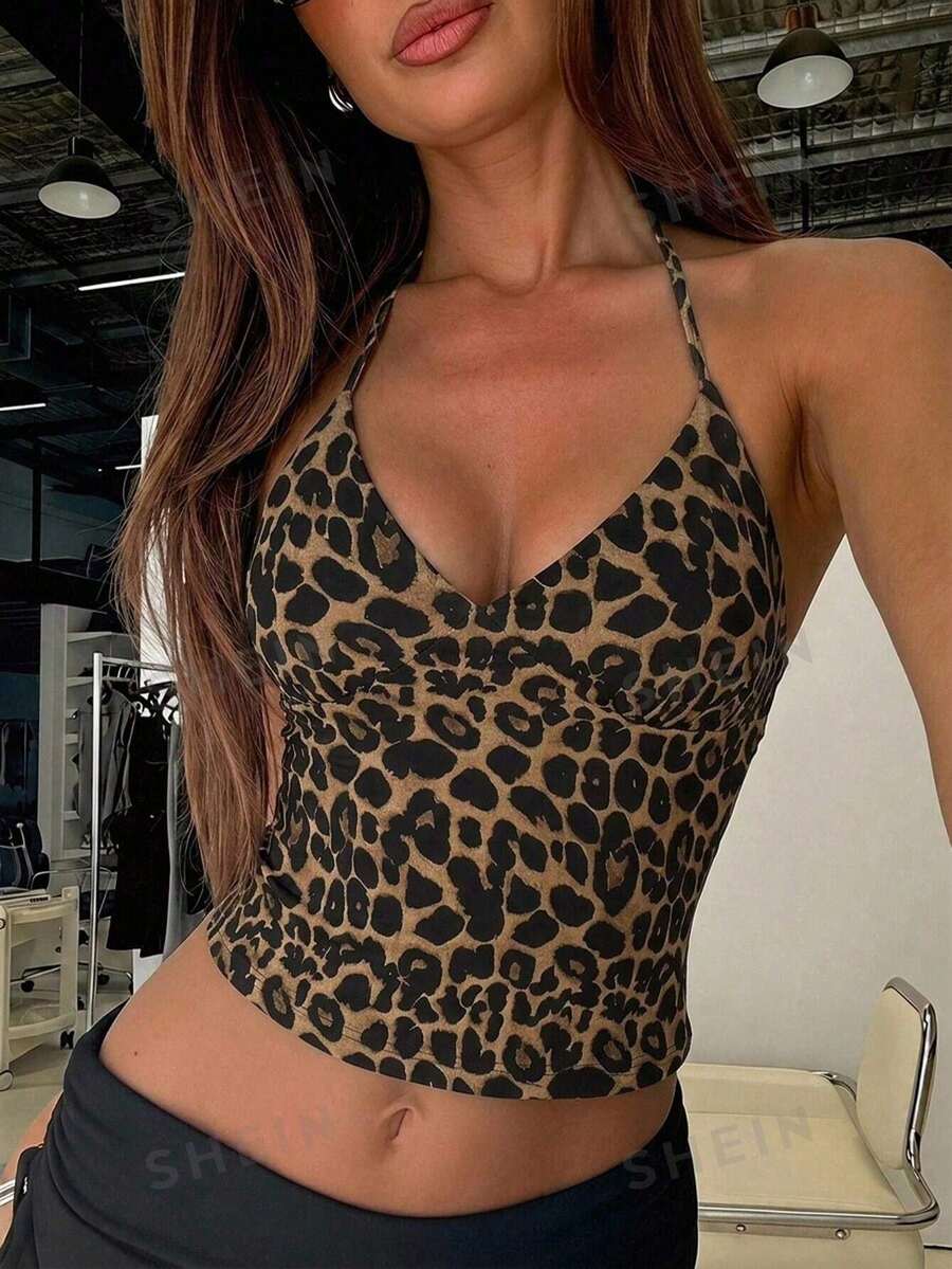 Women's black faux leather backless cami top with spaghetti straps and lace-up shirred sides.