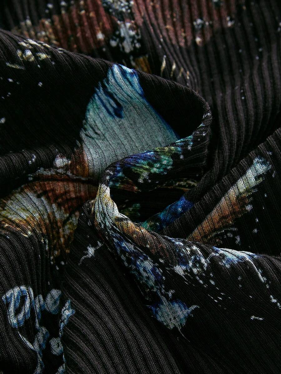 Black ribbed knit strapless crop tube top with an eye graphic print and star decor for women.