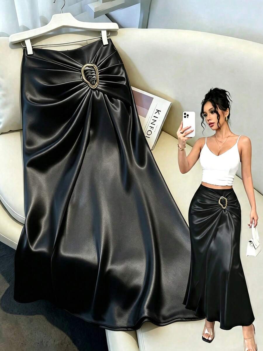 Women's elegant black long A-line skirt featuring woven satin ribbon design and metal buckle detail.