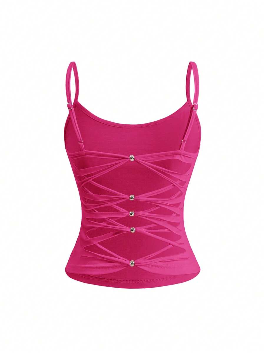 Woman wearing a black backless halter tank top with criss-cross details and textured knit fabric