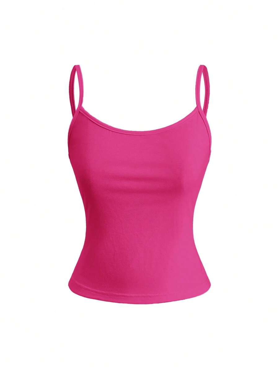 Woman wearing a black backless halter tank top with criss-cross details and textured knit fabric