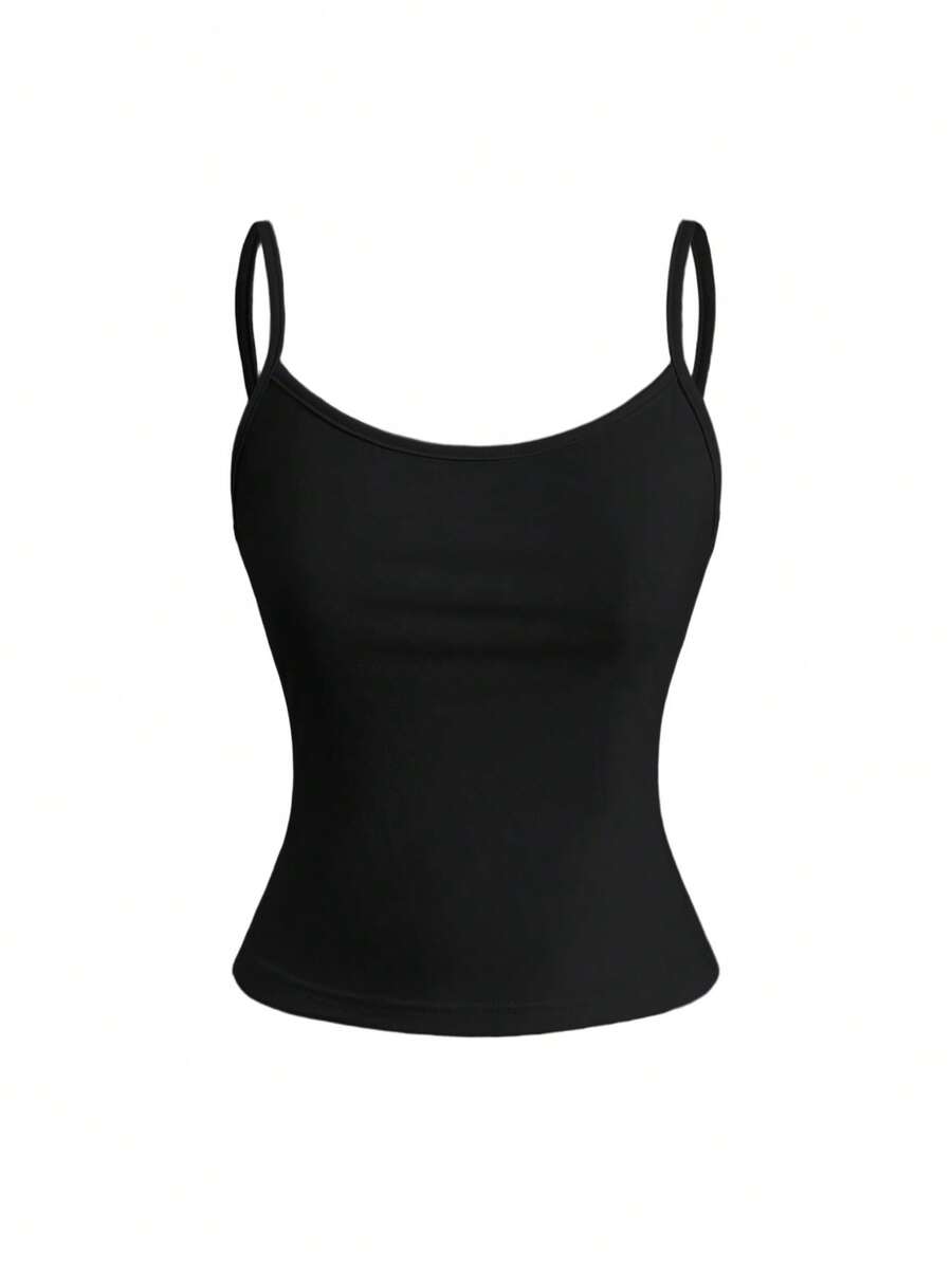 Woman wearing a black backless halter tank top with criss-cross details and textured knit fabric