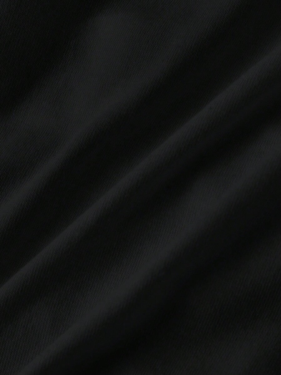 Woman wearing a black backless halter tank top with criss-cross details and textured knit fabric