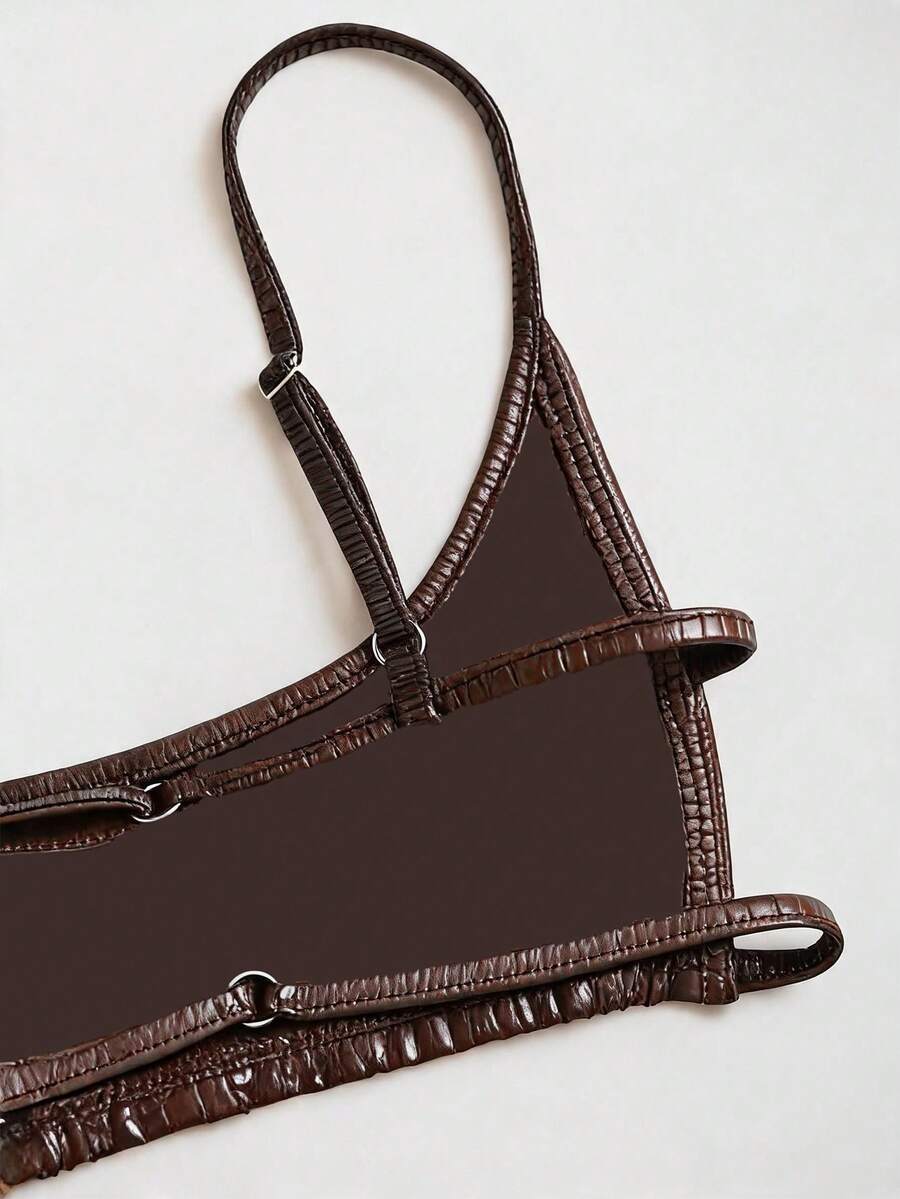 Women's black cropped camisole top with faux crocodile texture, backless spaghetti straps, and matching arm sleeves.