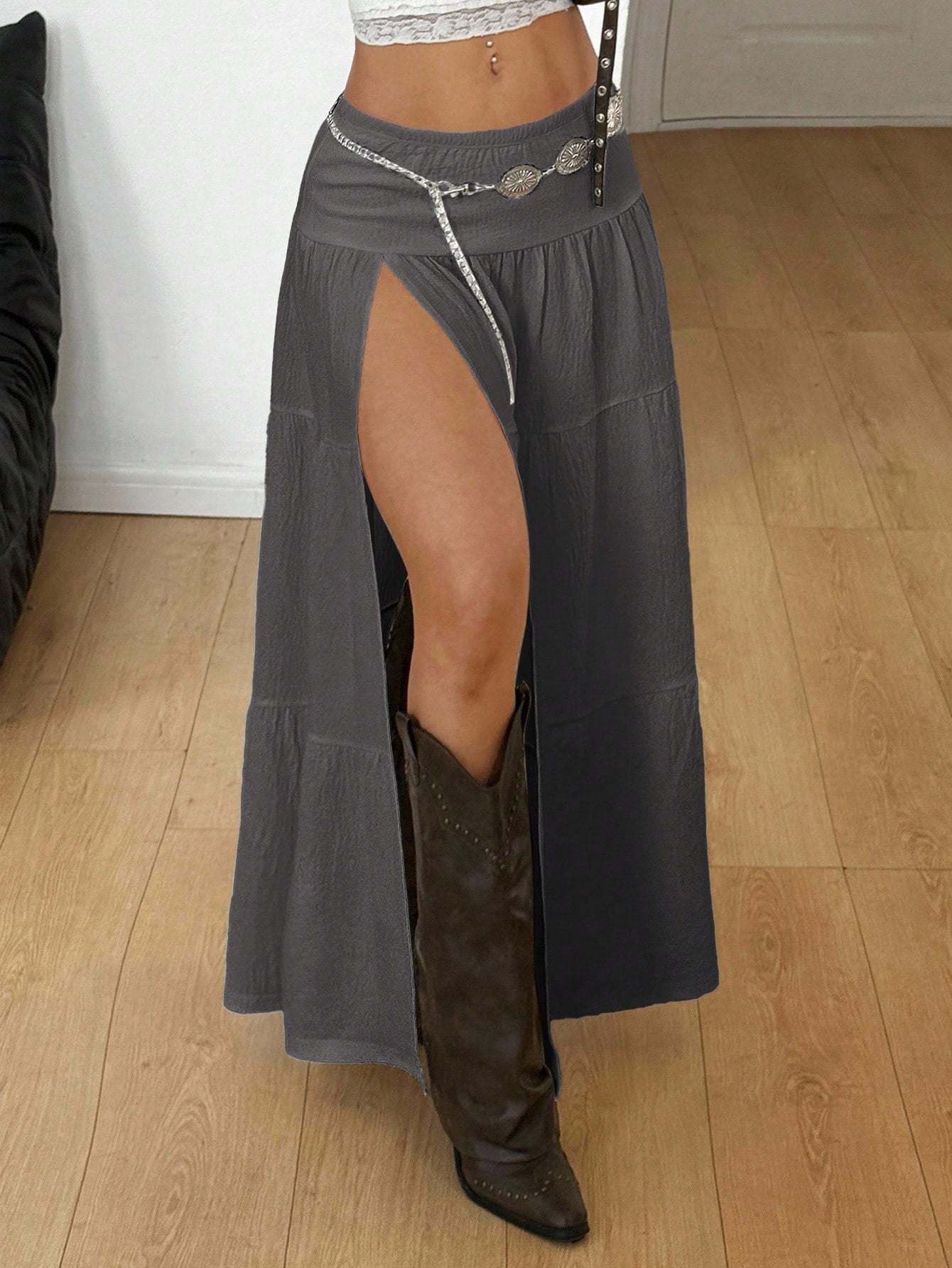 Women's black low waist split thigh long skirt featuring semi-sheer textured fabric and a flared skinny fit.