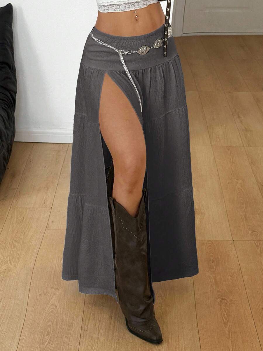 Women's black low waist split thigh long skirt featuring semi-sheer textured fabric and a flared skinny fit.