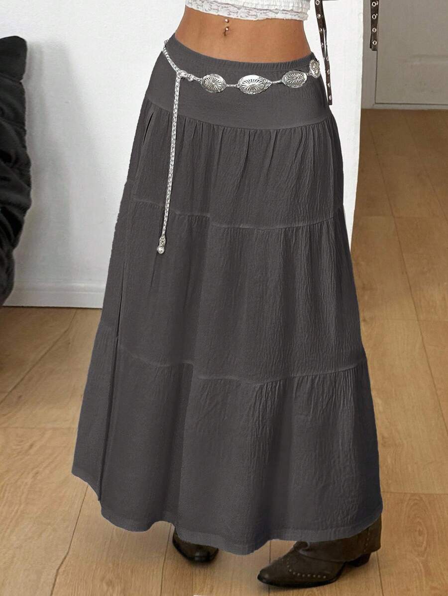 Women's black low waist split thigh long skirt featuring semi-sheer textured fabric and a flared skinny fit.