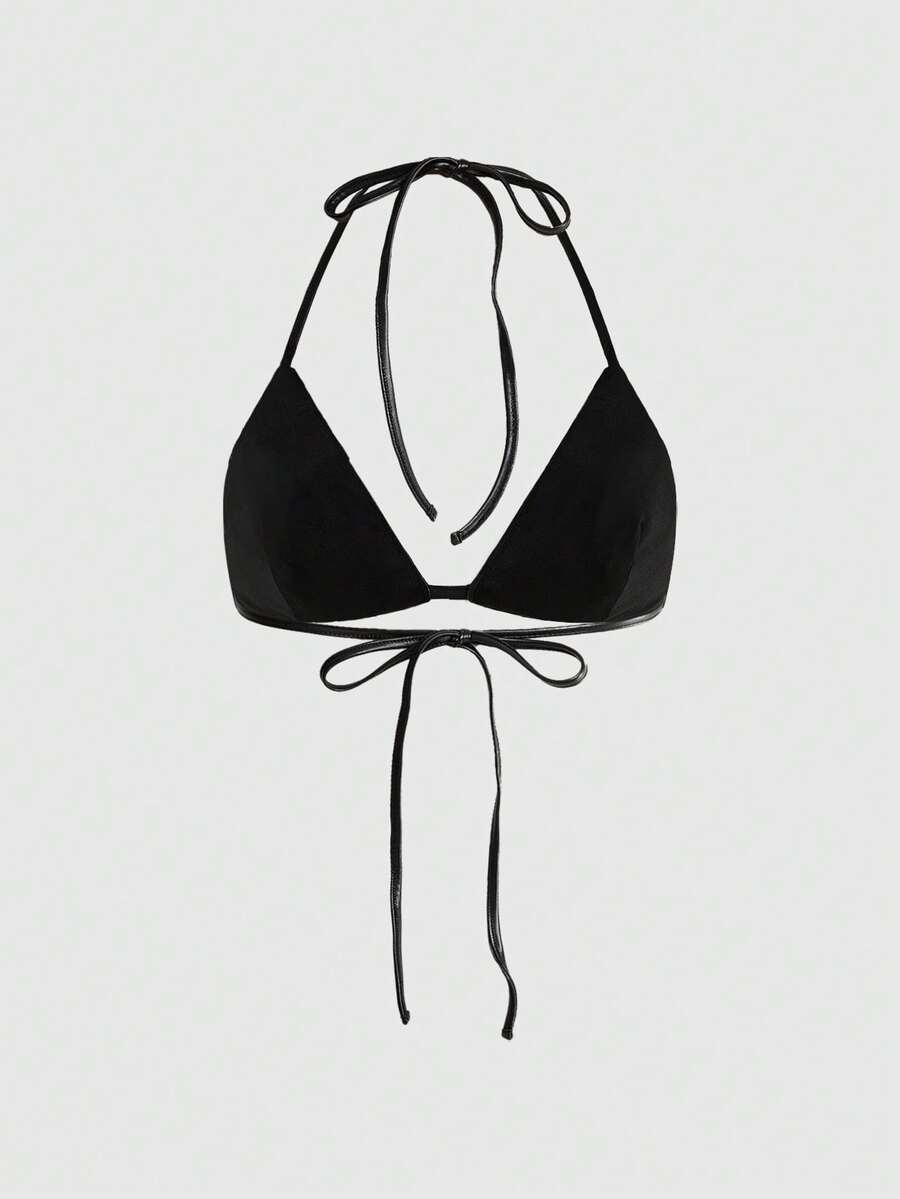 Black PU halter tank top featuring metal rivet design, triangle cups, micro crop length, and backless tie-back detail.