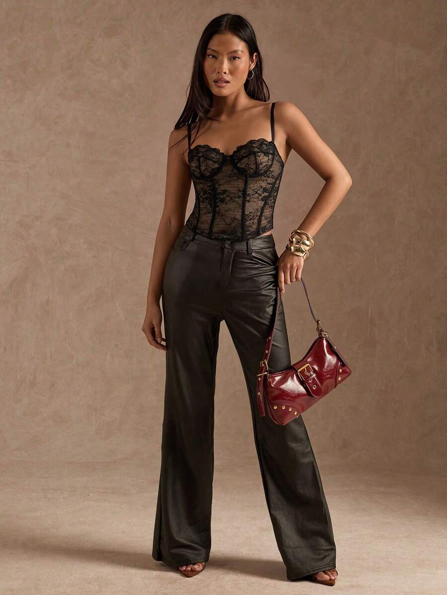 Black women’s lace cami top with spaghetti straps, contrast lace details, and an asymmetrical hem, styled as a slim-fit lined casual top.