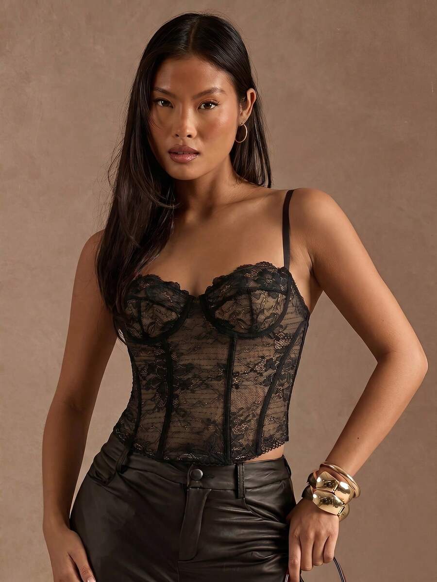 Women’s camisole top with cup detail, spaghetti straps, lined body, and slim fit design in knitted fabric with an asymmetrical hem.