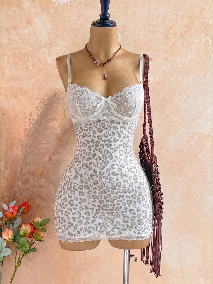 Women's black mesh bodycon mini dress featuring spaghetti straps, contrast lace cup details, backless styling, and a slim fit.