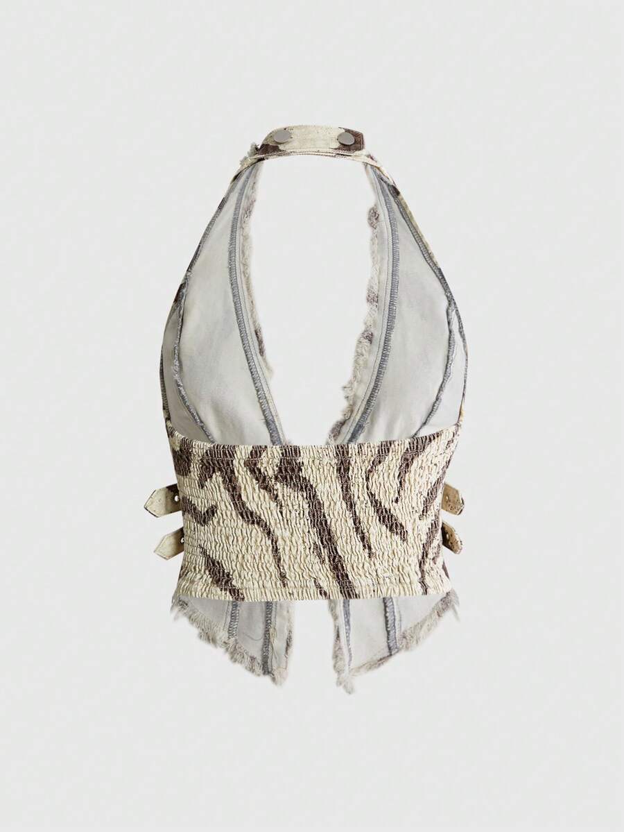 Women's denim halter crop top featuring a backless design, asymmetrical hem, single-breasted front, and lettuce trim.