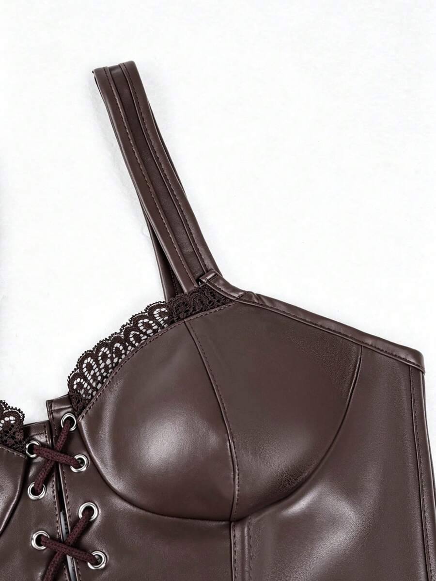 Women's black PU leather fishbone corset crop top featuring a lace-up front with metal eyelets and an asymmetrical hem.