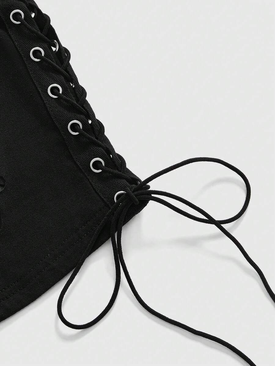 A black slim-fit women's crop tank top featuring a flocked spider web print, front metal eyelet lace-up detail, cut-out design, and round neckline.