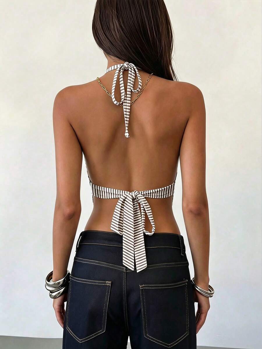 Women's black faux leather backless cami top with spaghetti straps and lace-up shirred sides.