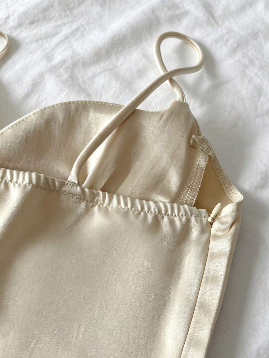 Women's woven spaghetti strap camisole with cup detail and cropped length in apricot.