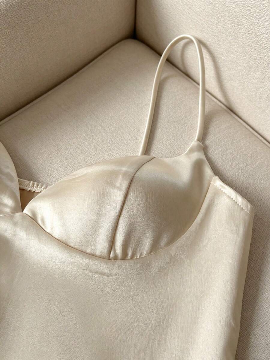 Women's woven spaghetti strap camisole with cup detail and cropped length in apricot.