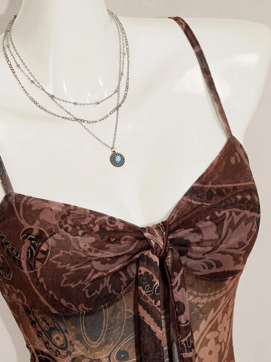 Burgundy paisley print ruched cami top for women featuring thin spaghetti straps, asymmetrical lace-up detail, and a slim fit.