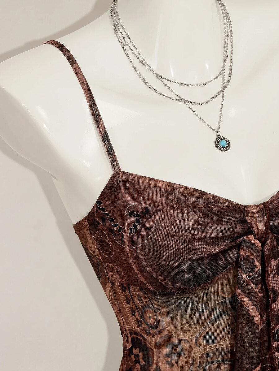Burgundy paisley print ruched cami top for women featuring thin spaghetti straps, asymmetrical lace-up detail, and a slim fit.